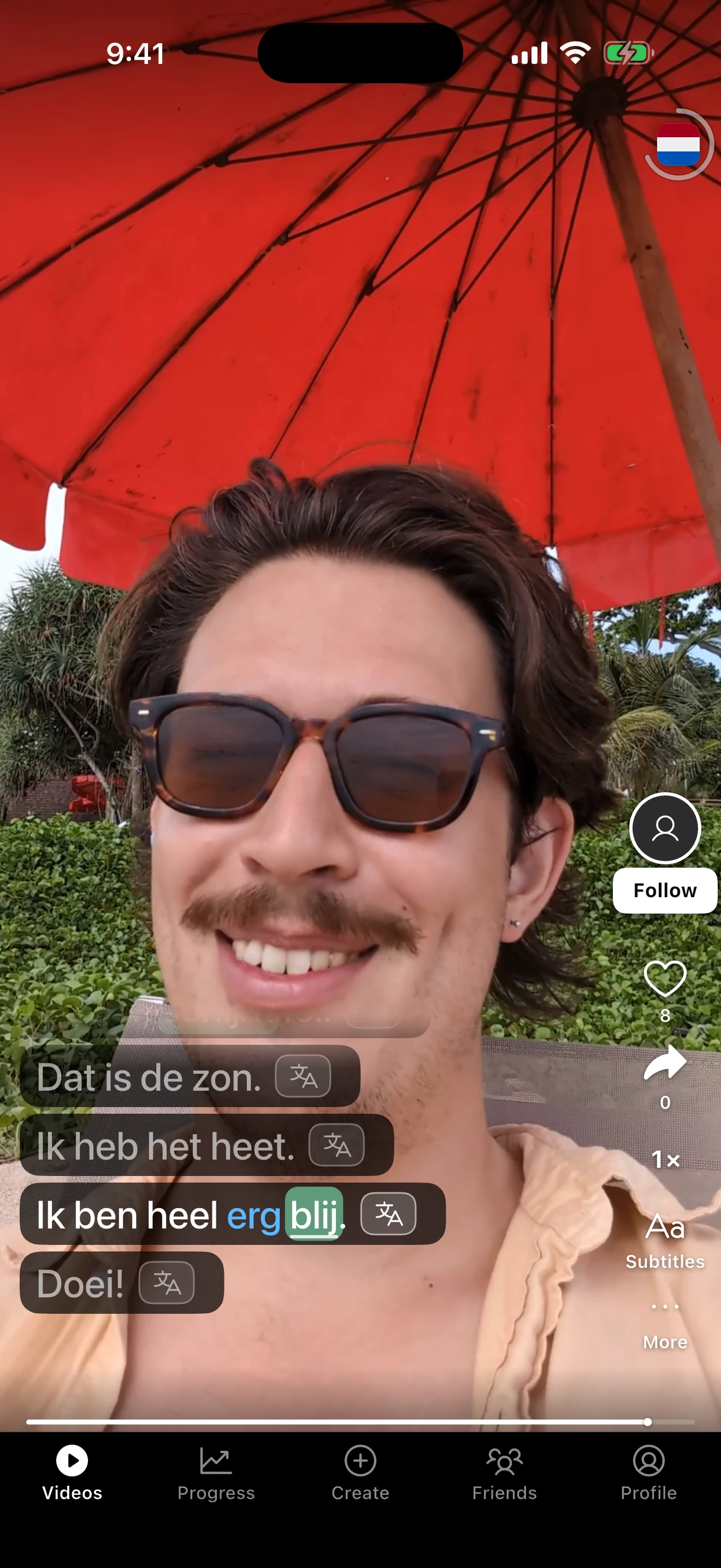A Dutch video in the Polygloat feed: a man under a red beach umbrella, with the subtitles “Ik heb het heet.” and “Ik ben heel erg blij.”